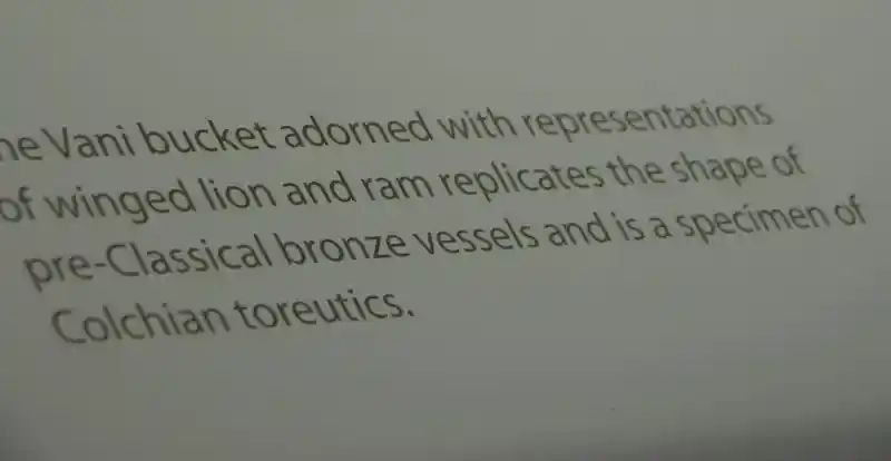 A winged lion on top of two rams